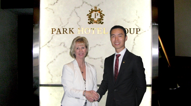 Allen Law, CEO of Park Hotel Group and Jenny Adams, CEO of Discover the World, extending a firm handshake symbolic of a robust partnership to come. 